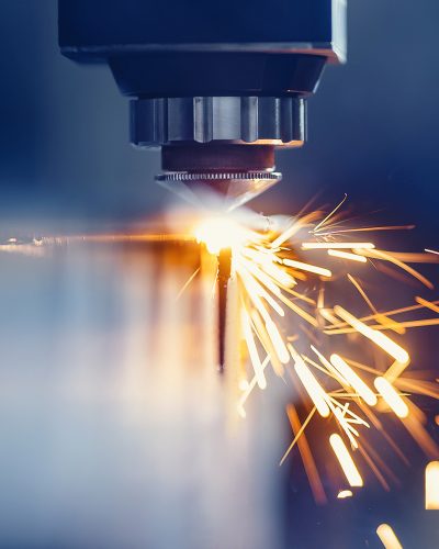 CNC gas cutting metal sheet, sparks fly. Blue steel color, modern industrial technology.