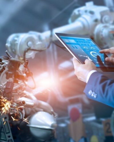 Manager engineer check and control automation robot arms machine in intelligent factory industrial on real time monitoring system software. Welding robotics and digital manufacturing operation.